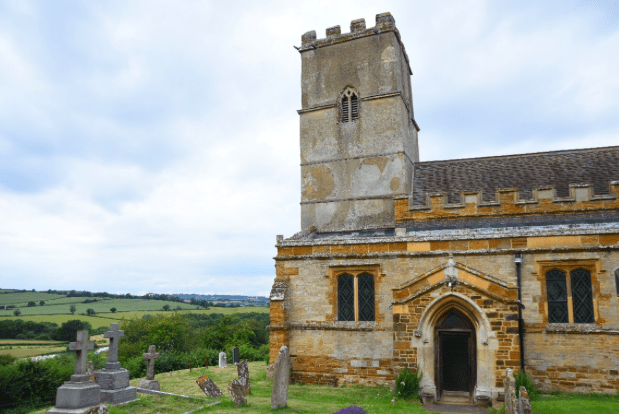 Photograph of a stone church with a tower