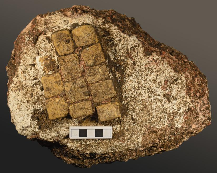 A small section of mosaic flooring. All the tiles are yellow