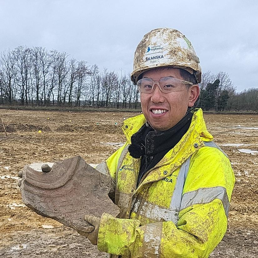 Archaeologist during excavations holding a piece of amphora