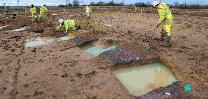 Archaeologists excavating a roundhouse
