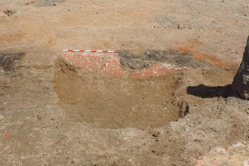 A small section of floor made from orange mosaic tiles