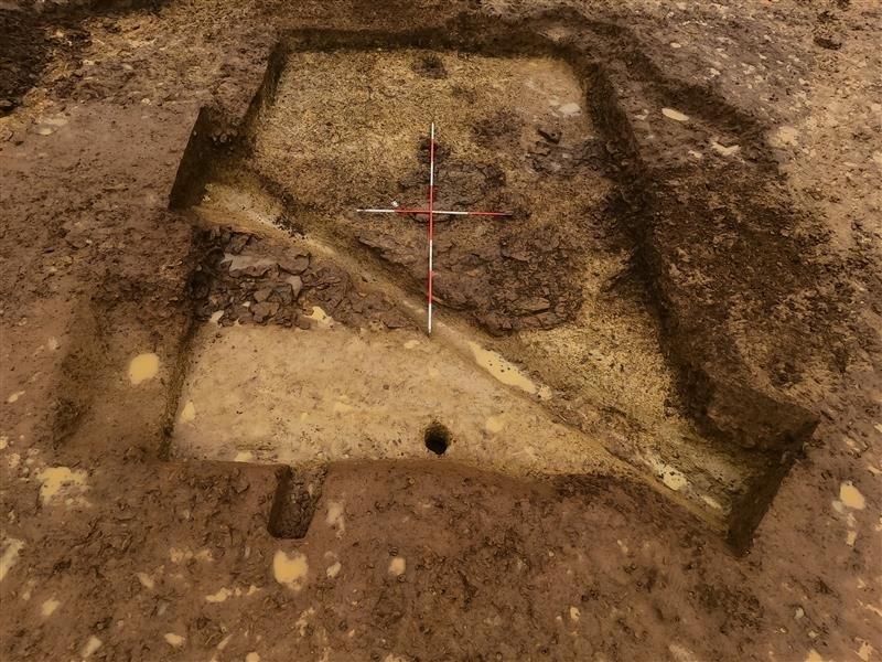 A rectangular area with a ditch running diagonally across it from left to right