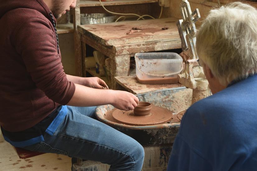 participant wheel throwing a pot