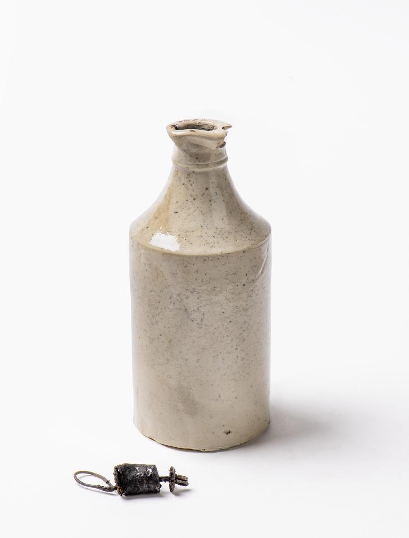 Cream coloured ceramic bottle with a small stopper