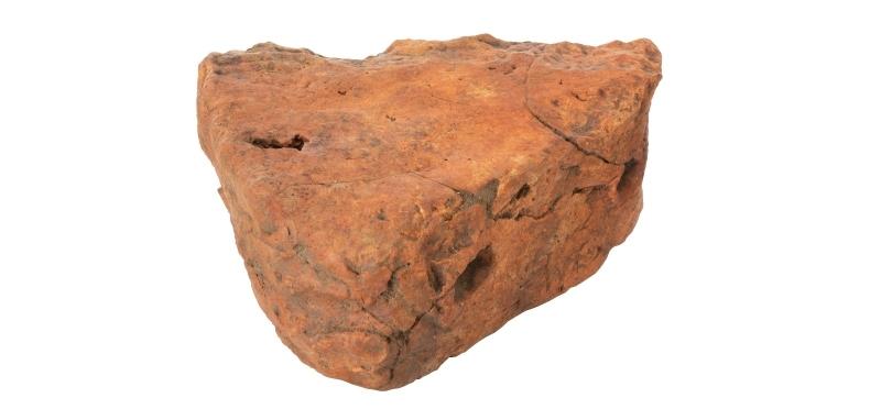 Triangle shaped loomweight made from dark orange clay