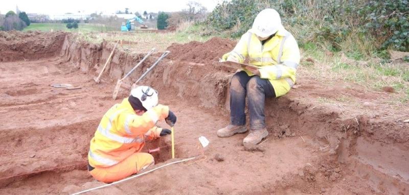 Archaeologists recording a feature