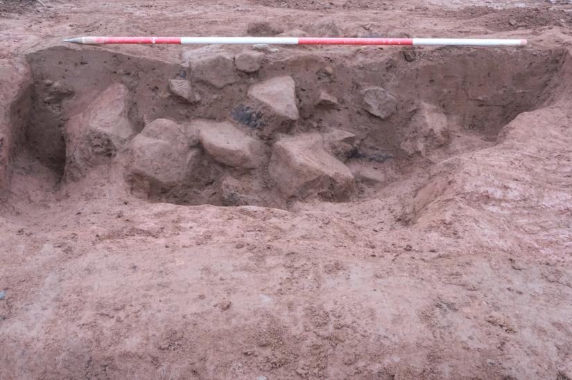 Excavated pit filled with stone