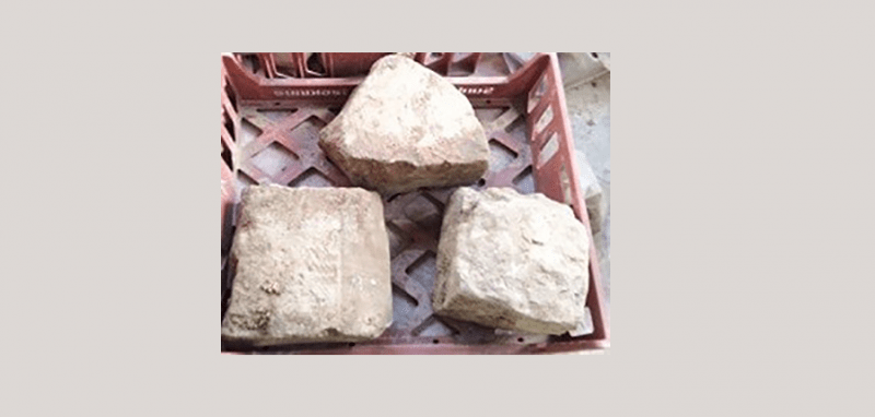 three pieces of stone in a crate