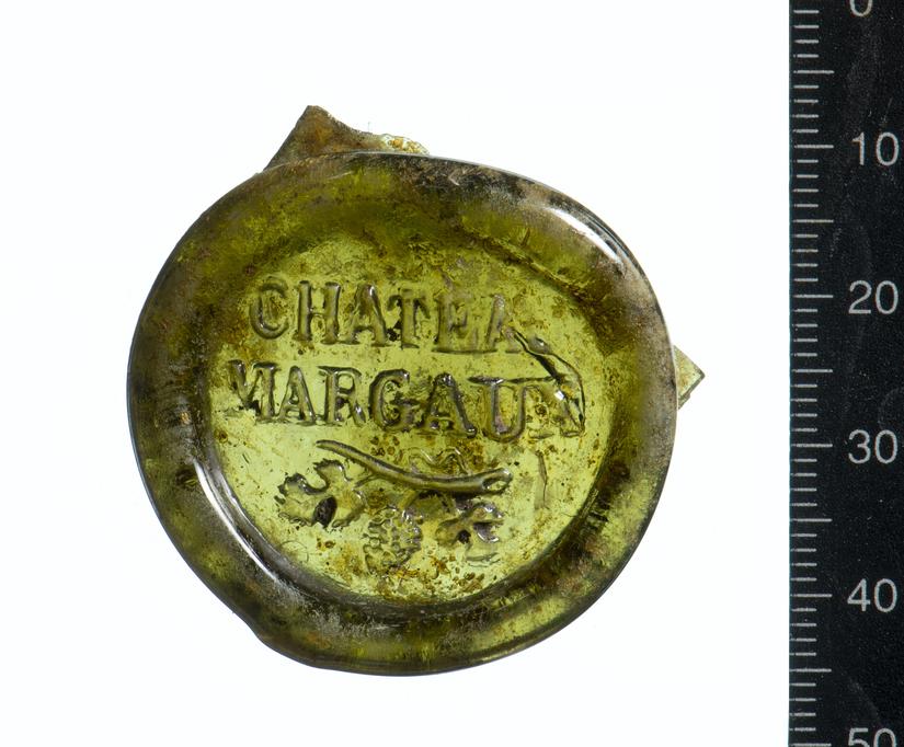 A green circular glass seal which reads Chateau Margaux in the centre