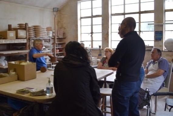 Participants learning about pottery from master potter Rod Bibby