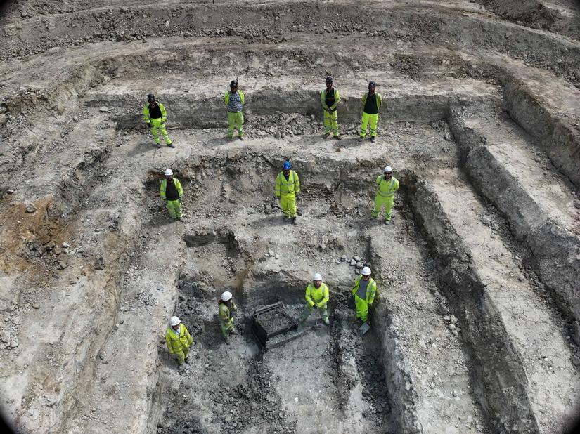 Archaeologists stood in a large stepped trench