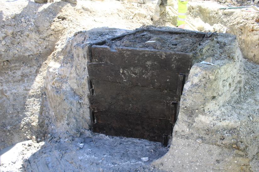 The wooden boards of the well exposed on one side during excavations