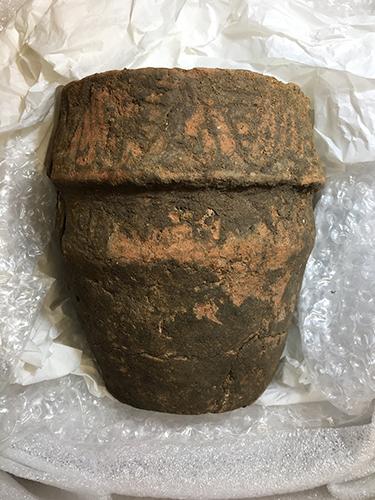 A complete pottery urn with a wide rim/collar