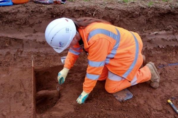 Archaeologist taking a sample of charcoal