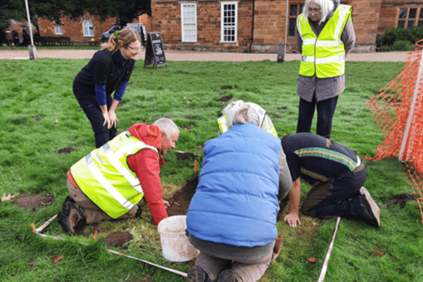 Visitors look into the test pit