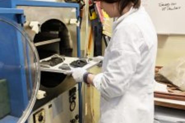 The slippers on a tray being places into a machine