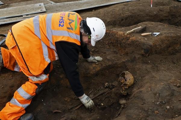 An archaeologist excavating a grave