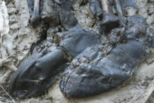 The preserved leather boots during excavation