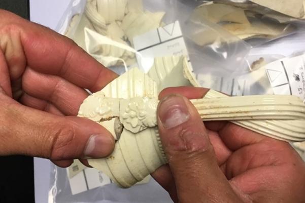 hand holding a cream pottery handle