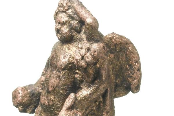 Gold coloured small statue of a boy with wings