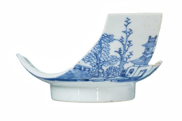 base and one side of a white rice bowl with blue decoration