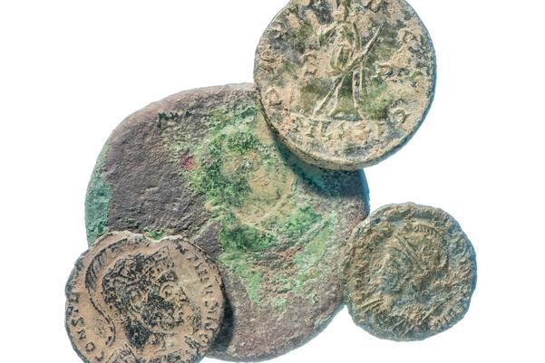 Four Roman coins of different sizes