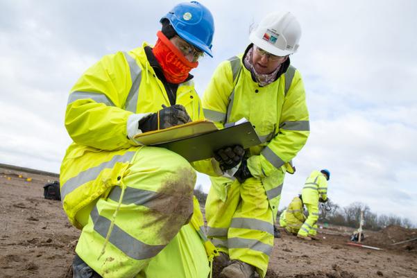 A trainee filling out paperwork in the field