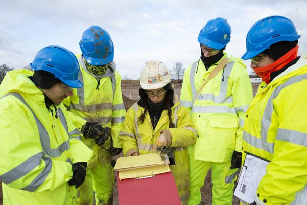 A group of trainees looking at paperwork