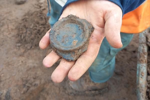 hand holding the base of a jug, cup or bowl