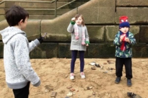 Photo of children looking at objects found on the foreshore