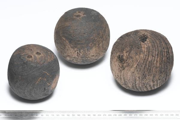 Three wooden bowling balls