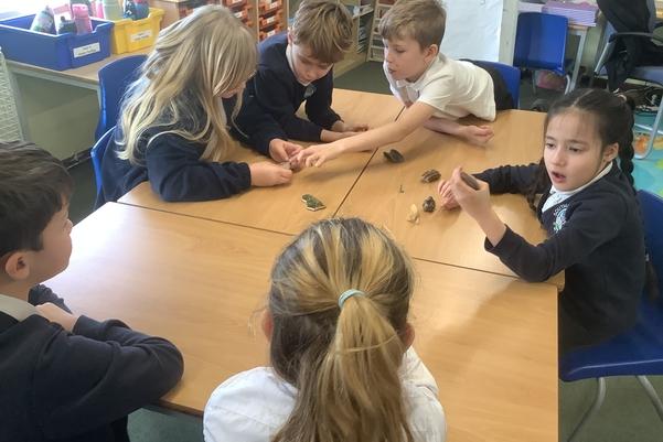 children looking at archaeological finds on a table
