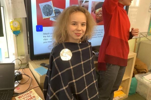 A child wearing their badge