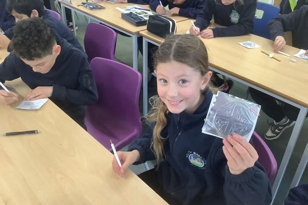 A child showing off their art