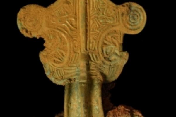 Close up photo of a Saxon brooch decorated with swirls and lines