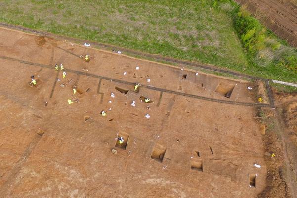 Aerial photograph of the archaeological excavations. Running through the middle is a wide dark line, this is the Roman ditch