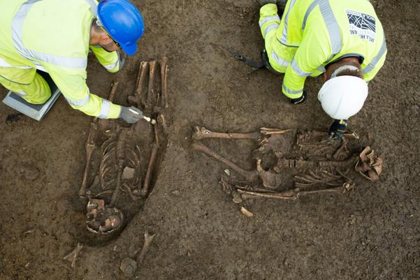 Archaeologists excavating two Roman burials