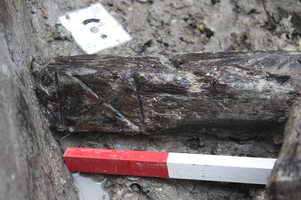 A piece of wood with a saltire (x-shaped) decoration