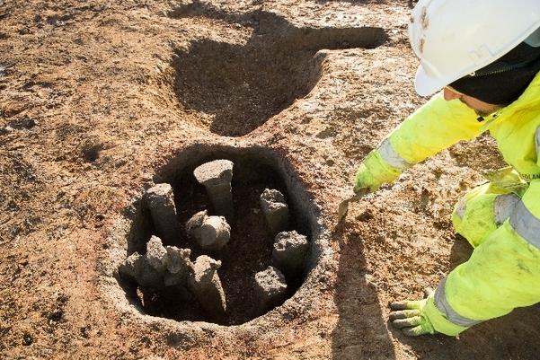 An archaeologist excavating a Roman kiln