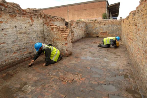 Archaeologist excavating the remains of the building