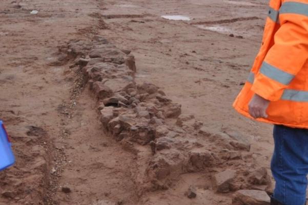 Looking down a line of rubble wall foundation