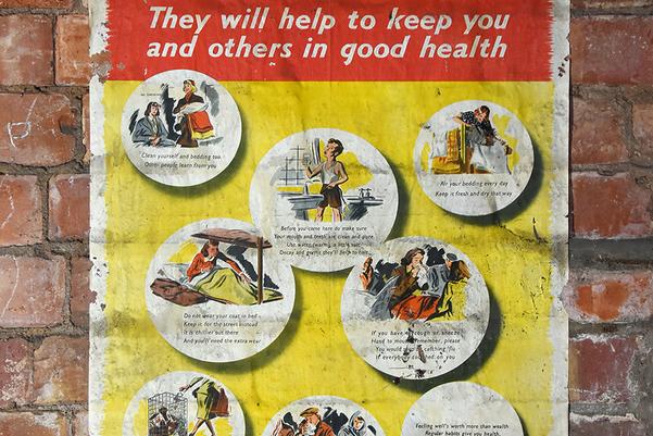 A WWII poster on a brick wall about how to stay healthy