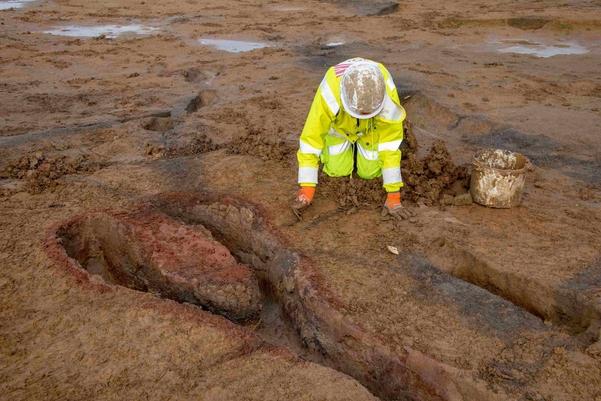 An archaeologist excavates a Roman kiln