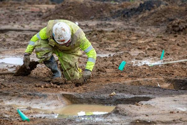 An archaeologist excavating an Iron Age roundhouse