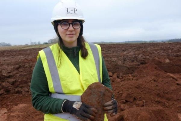 Archaeologist holding a slate roof tile