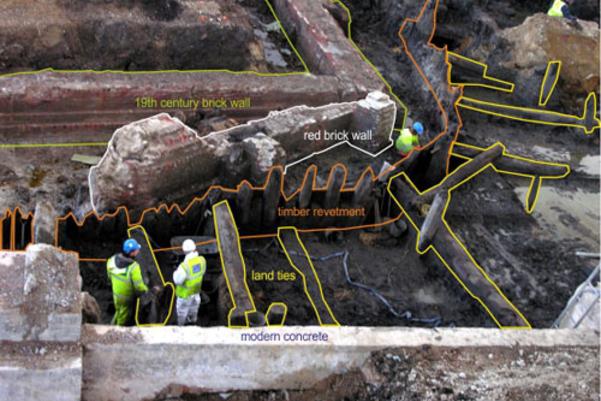 The excavated basin wall with the building phases drawn on