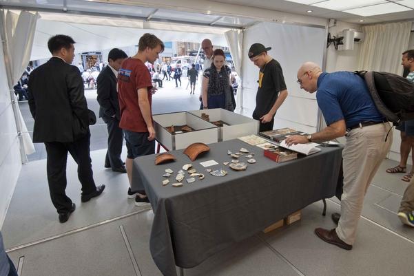 Visitors interacting with archaeological artefacts in the time truck