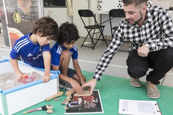 Two children learning about archaeology in the Time Truck
