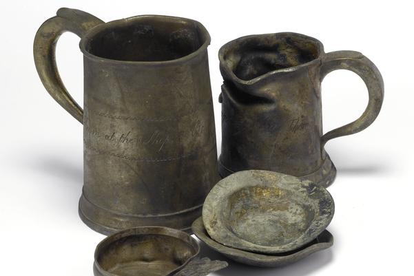 Two metal tankards and two small metal bowls