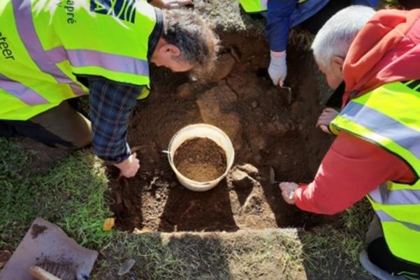 Volunteers digging in the test pit